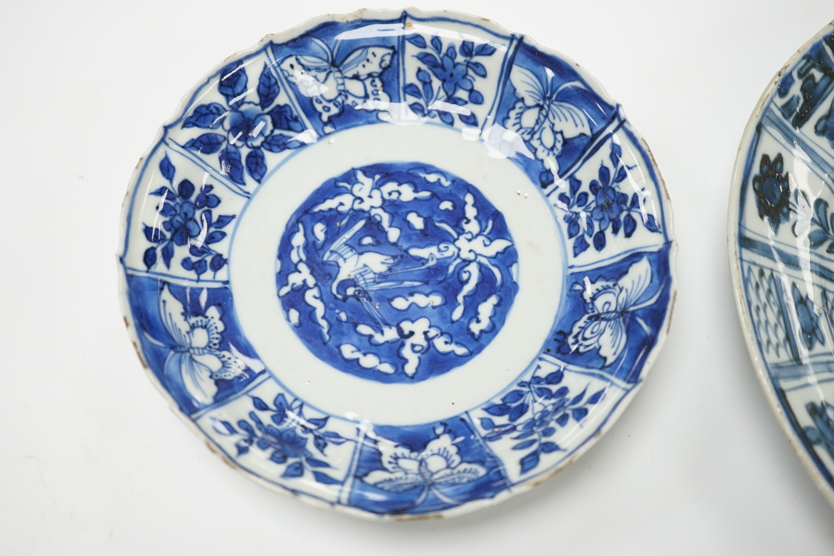 A Chinese 'Kraak porselein' blue and white plate and a Wanli blue and white saucer dish, largest 22cm diameter
